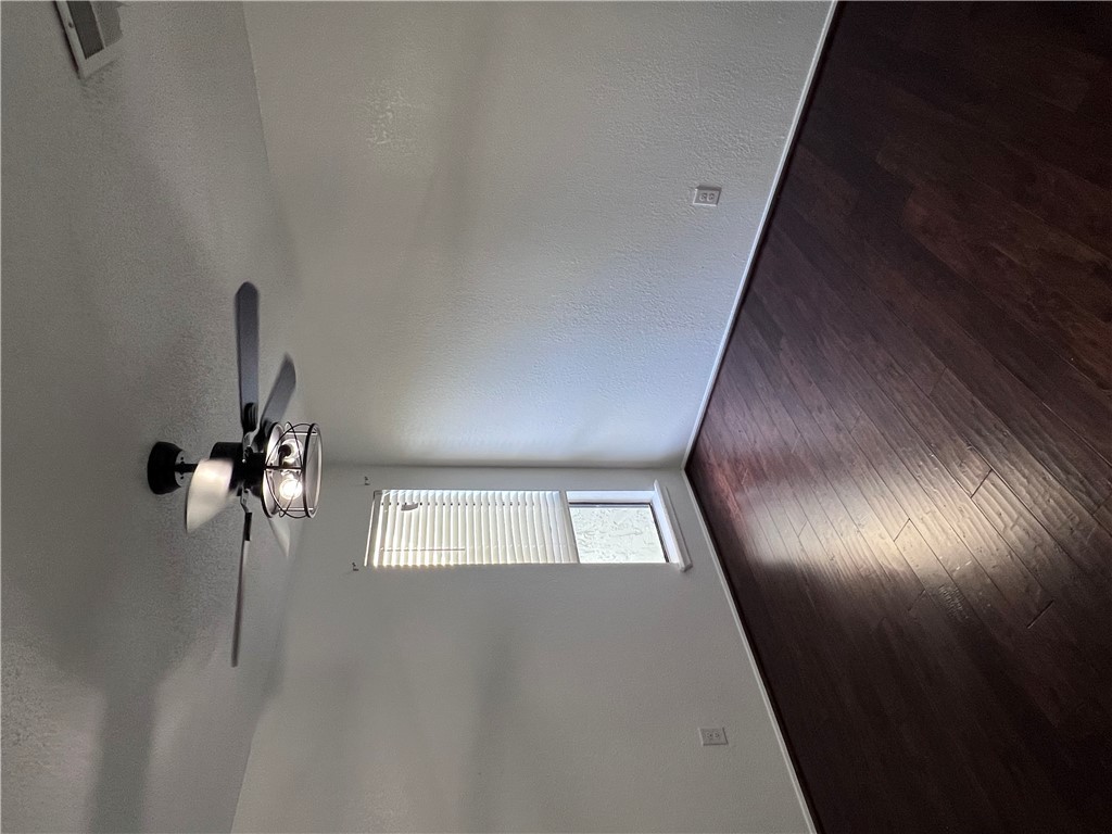 4507 Carter Creek Parkway, Unit 2 Bryan, TX 77802 - Photo 16 of 26 a view of an empty room with wooden floor and a window