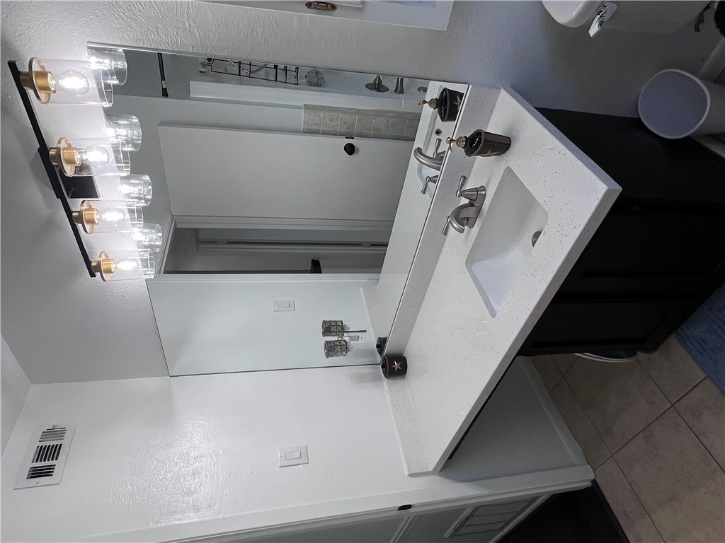 4507 Carter Creek Parkway, Unit 2 Bryan, TX 77802 - Photo 20 of 26 a bathroom with a sink and a mirror