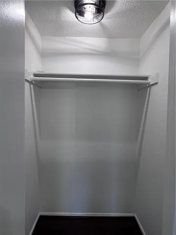 a view of a room with wooden floor and furniture