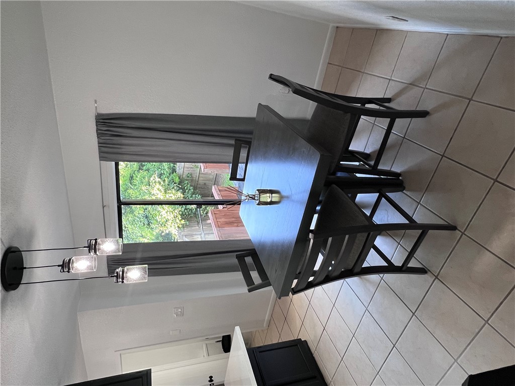 4507 Carter Creek Parkway, Unit 2 Bryan, TX 77802 - Photo 5 of 26 a view of a dining room with furniture window and wooden floor