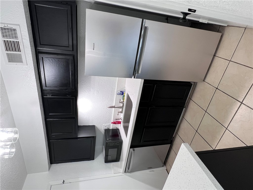 4507 Carter Creek Parkway, Unit 2 Bryan, TX 77802 - Photo 6 of 26 a kitchen with stainless steel appliances a sink and a refrigerator