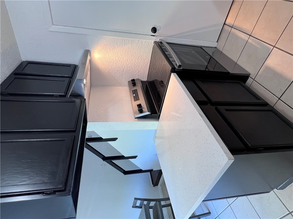 4507 Carter Creek Parkway, Unit 2 Bryan, TX 77802 - Photo 7 of 26 a kitchen with stainless steel appliances a sink dishwasher stove and cabinets