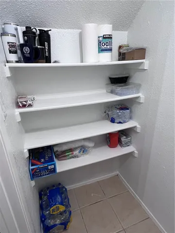 a bathroom with a sink a light fixture and a mirror