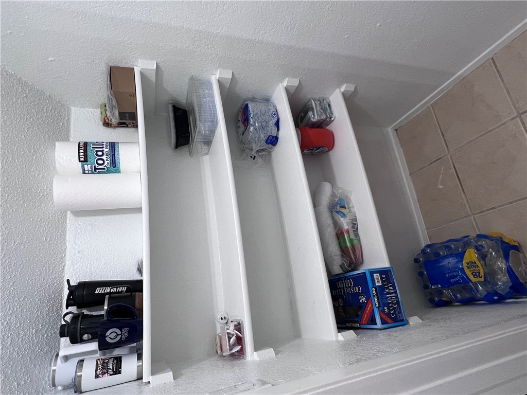 4507 Carter Creek Parkway, Unit 2 Bryan, TX 77802 - Photo 8 of 26 a shelf with books and knick knacks on it