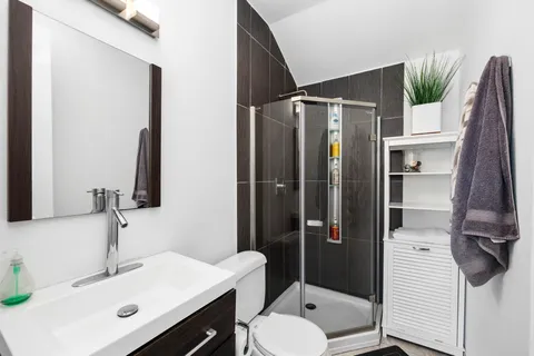 a bathroom with a sink toilet and shower