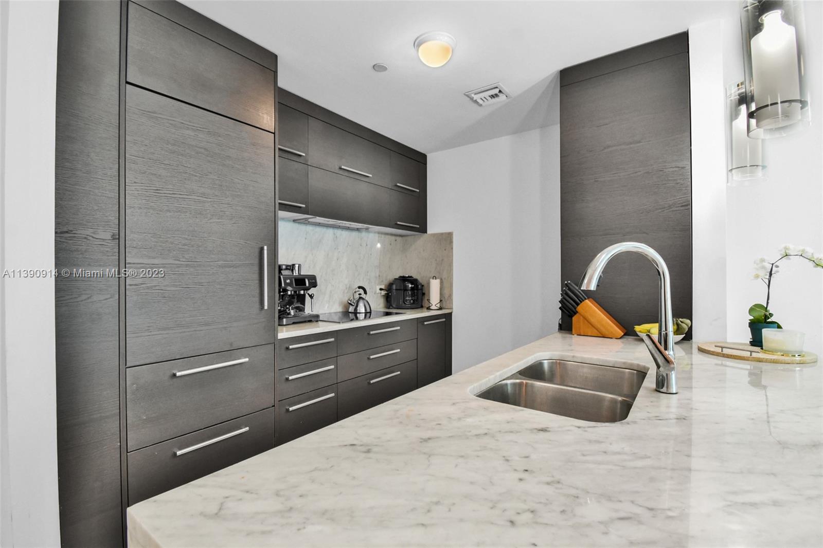 900 Biscayne Boulevard, Unit 4510 Miami, FL 33132 - Photo 11 of 48 a kitchen with a sink and a refrigerator