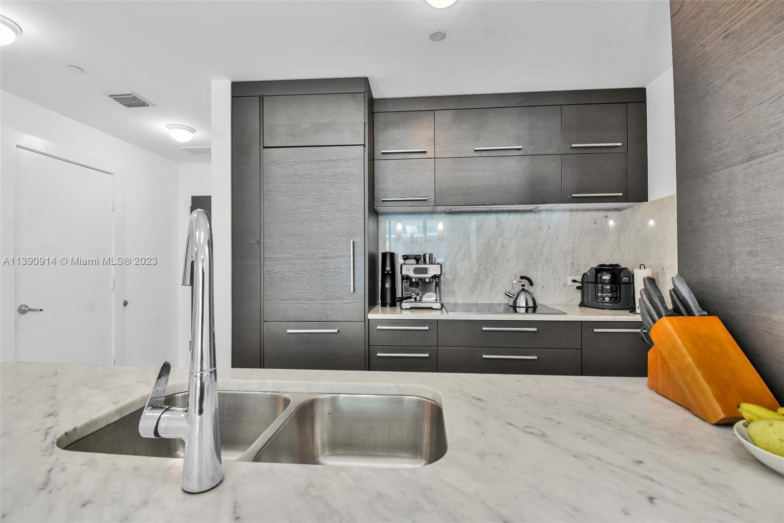 900 Biscayne Boulevard, Unit 4510 Miami, FL 33132 - Photo 12 of 48 a kitchen with stainless steel appliances granite countertop a sink and refrigerator