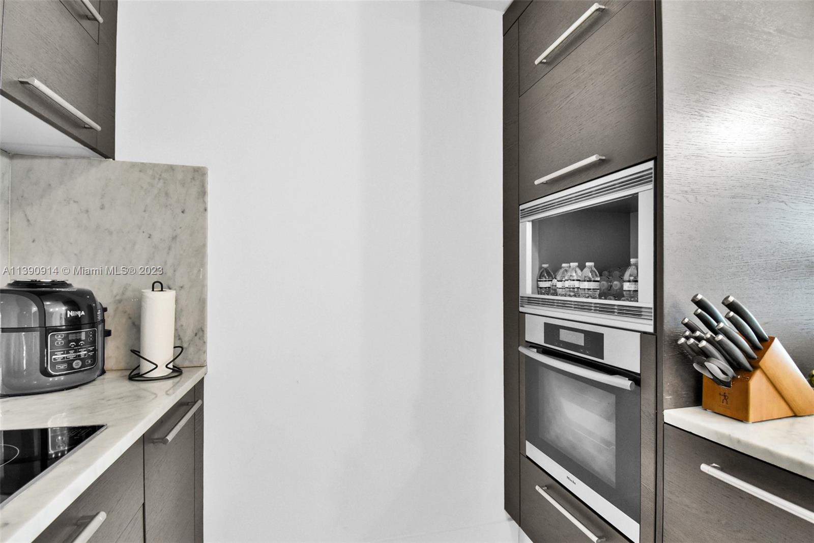 900 Biscayne Boulevard, Unit 4510 Miami, FL 33132 - Photo 13 of 48 a kitchen with a refrigerator and a stove top oven