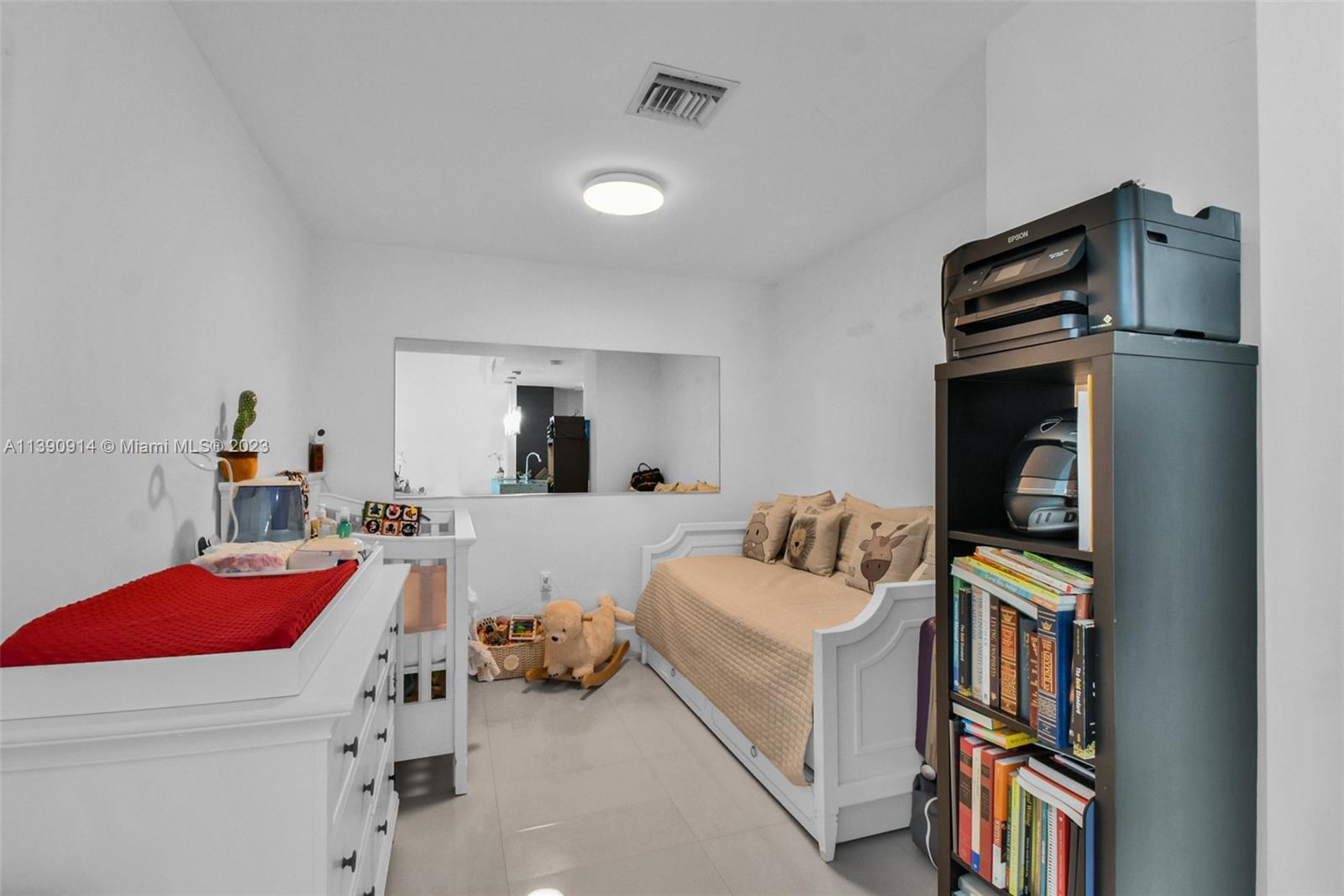 900 Biscayne Boulevard, Unit 4510 Miami, FL 33132 - Photo 17 of 48 a bedroom with furniture and a book shelf