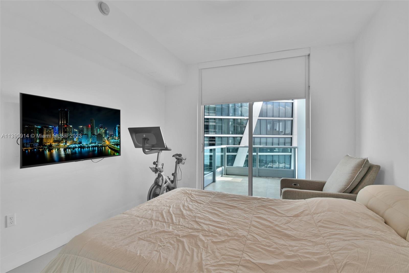 900 Biscayne Boulevard, Unit 4510 Miami, FL 33132 - Photo 19 of 48 a bedroom with a bed and a flat tv screen on dresser