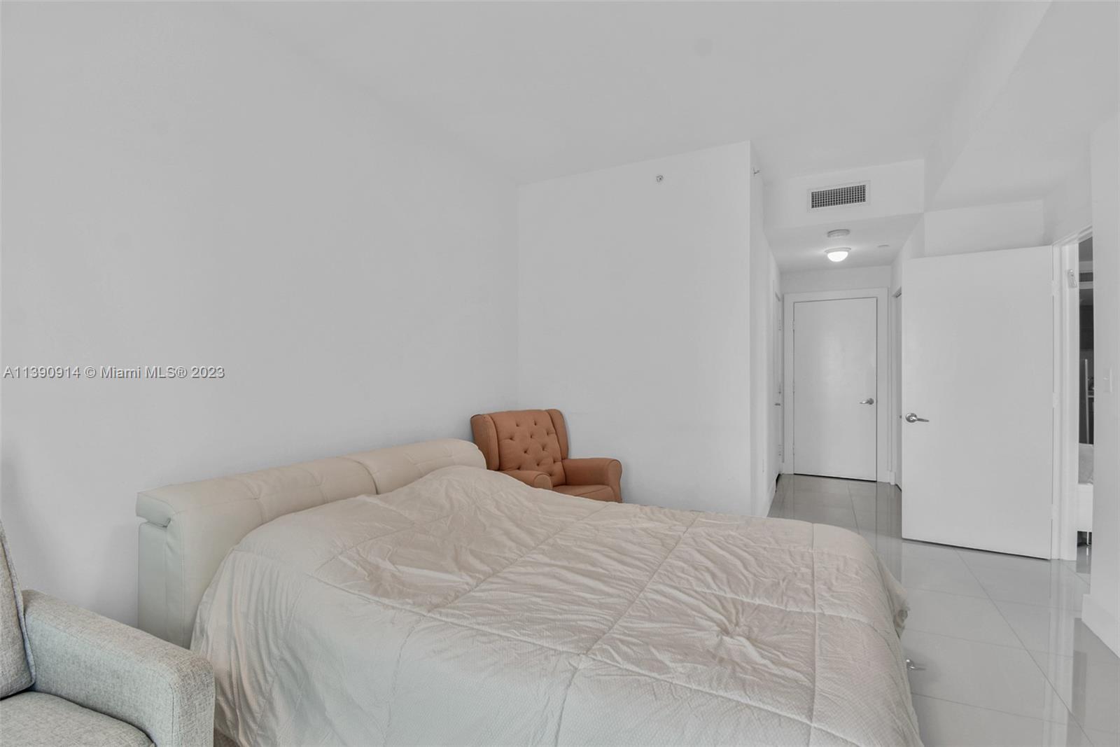 900 Biscayne Boulevard, Unit 4510 Miami, FL 33132 - Photo 20 of 48 a bedroom with a bed and a couch