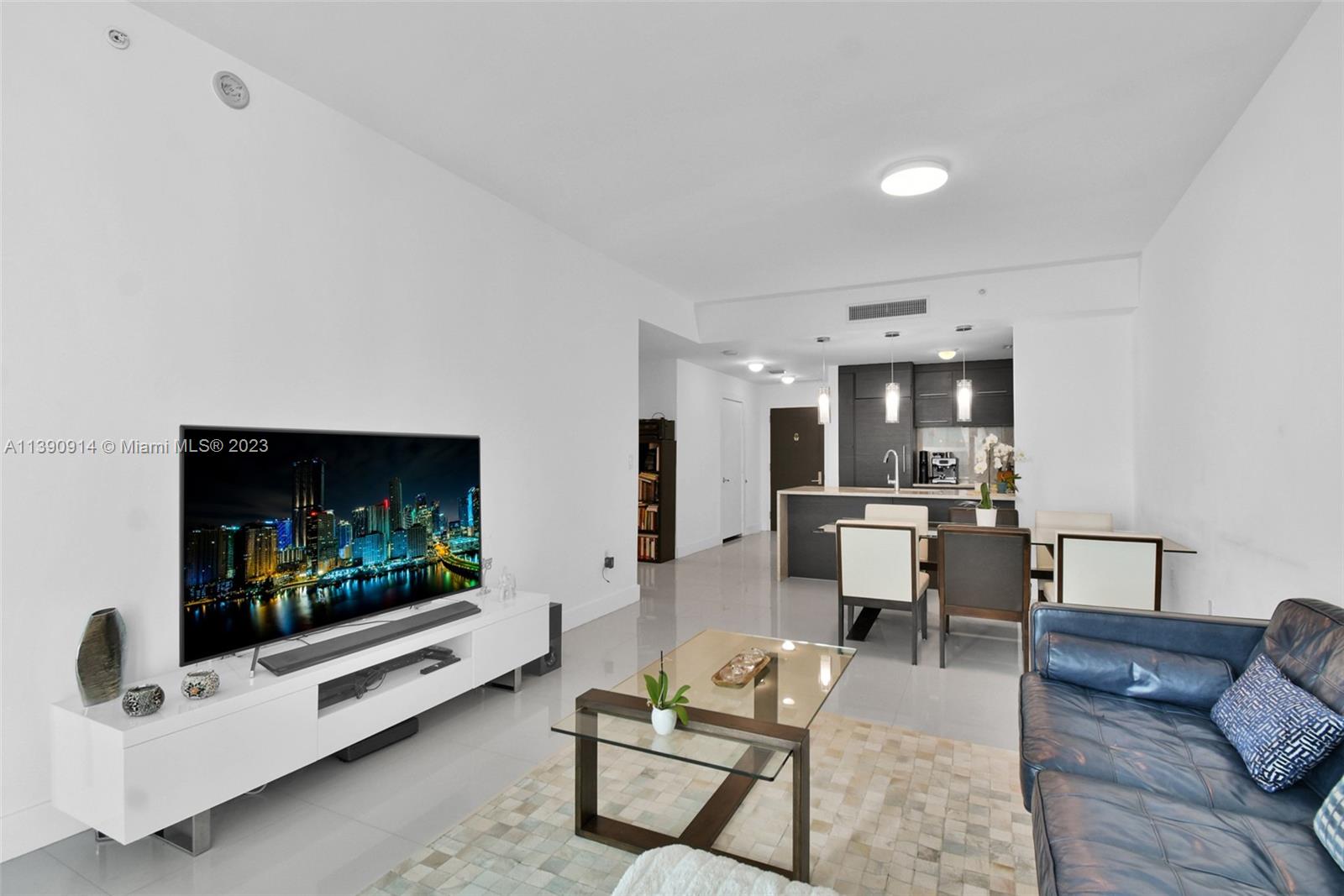 900 Biscayne Boulevard, Unit 4510 Miami, FL 33132 - Photo 2 of 48 a living room with furniture and a flat screen tv