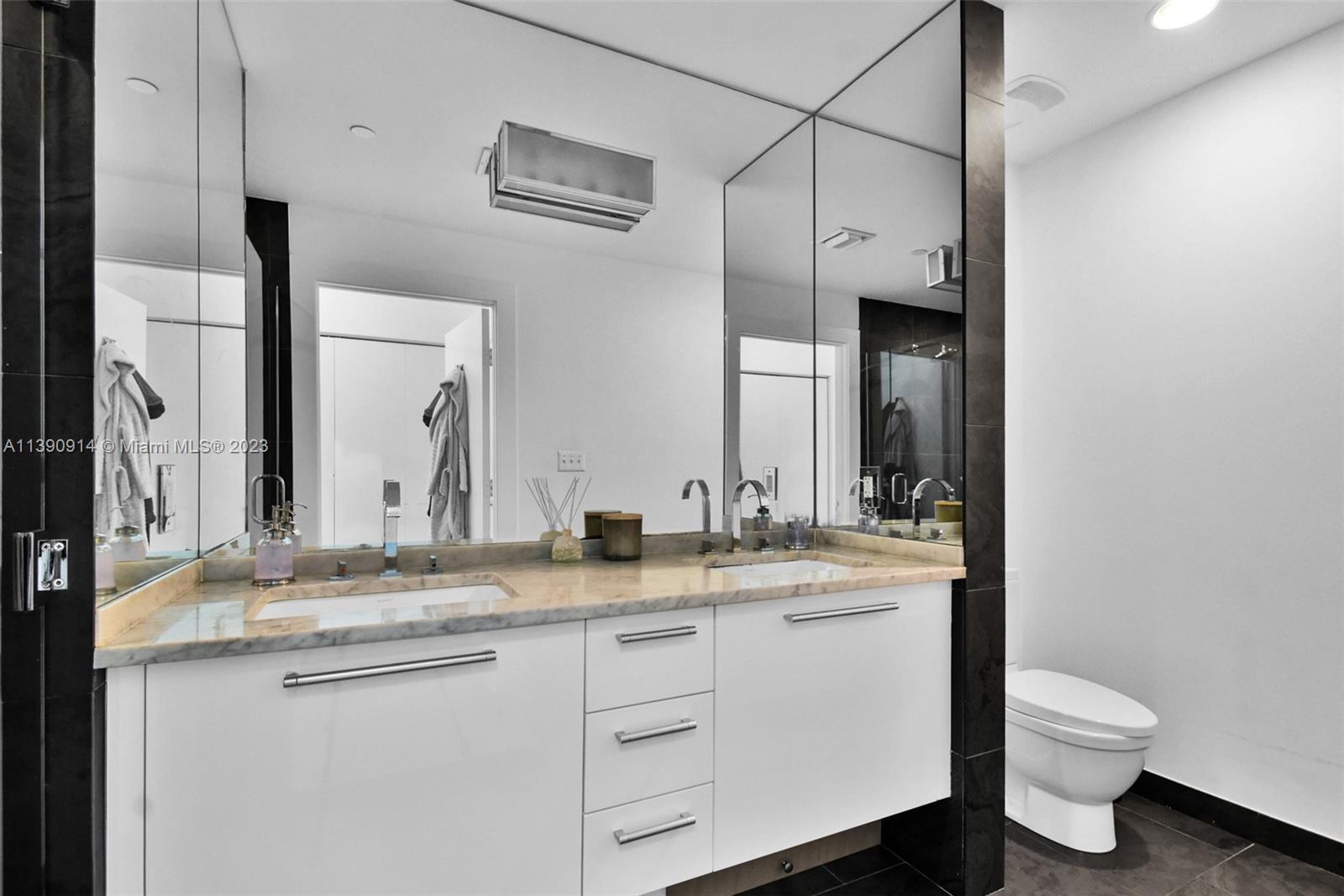 900 Biscayne Boulevard, Unit 4510 Miami, FL 33132 - Photo 23 of 48 a bathroom with a granite countertop sink mirror vanity and toilet