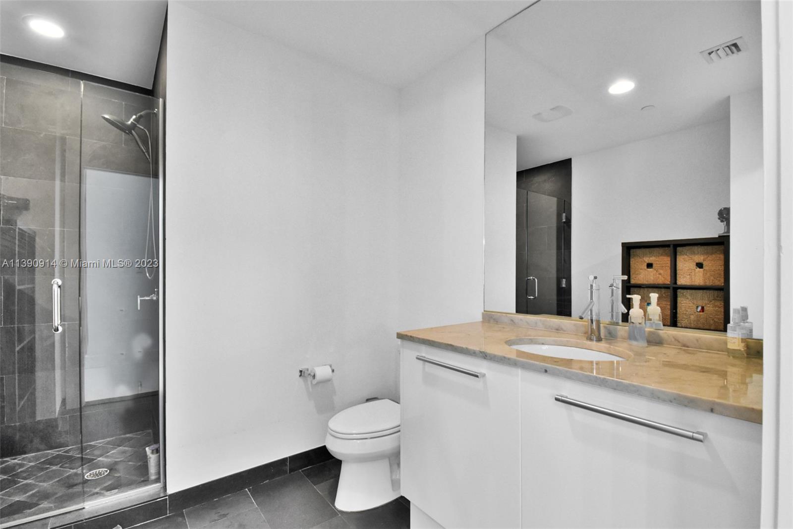 900 Biscayne Boulevard, Unit 4510 Miami, FL 33132 - Photo 39 of 48 a bathroom with a granite countertop sink toilet and shower