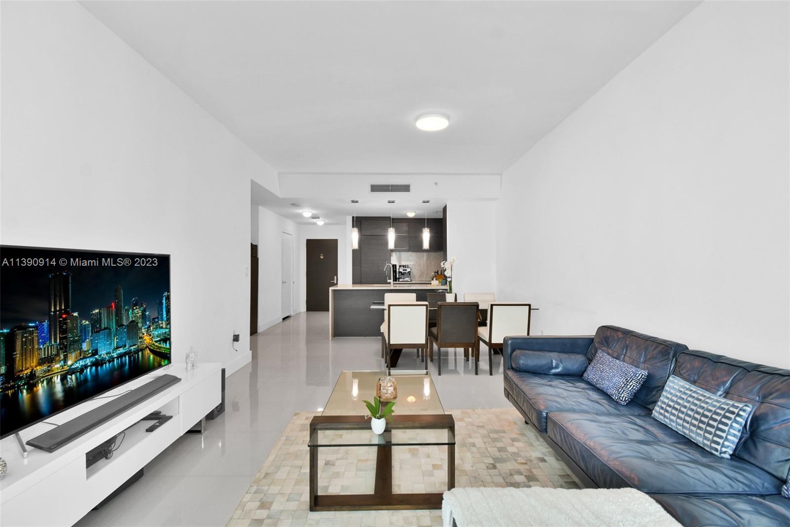 900 Biscayne Boulevard, Unit 4510 Miami, FL 33132 - Photo 4 of 48 a living room with furniture and a flat screen tv