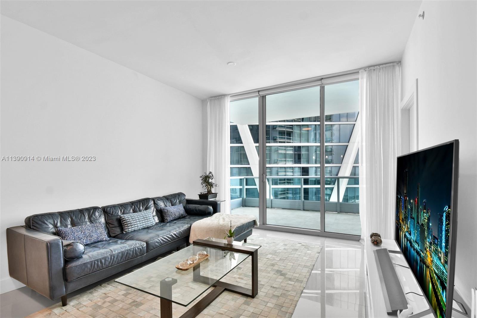 900 Biscayne Boulevard, Unit 4510 Miami, FL 33132 - Photo 5 of 48 a living room with furniture tv and a flat screen tv