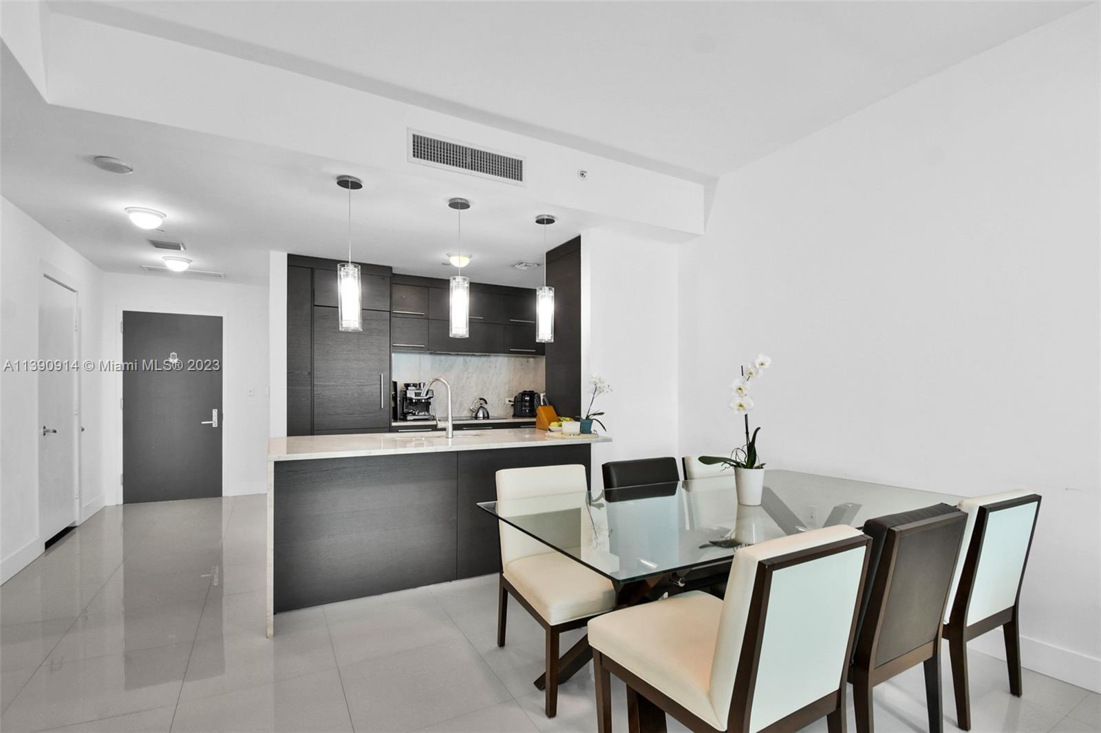 900 Biscayne Boulevard, Unit 4510 Miami, FL 33132 - Photo 7 of 48 a kitchen with a table and chairs in it