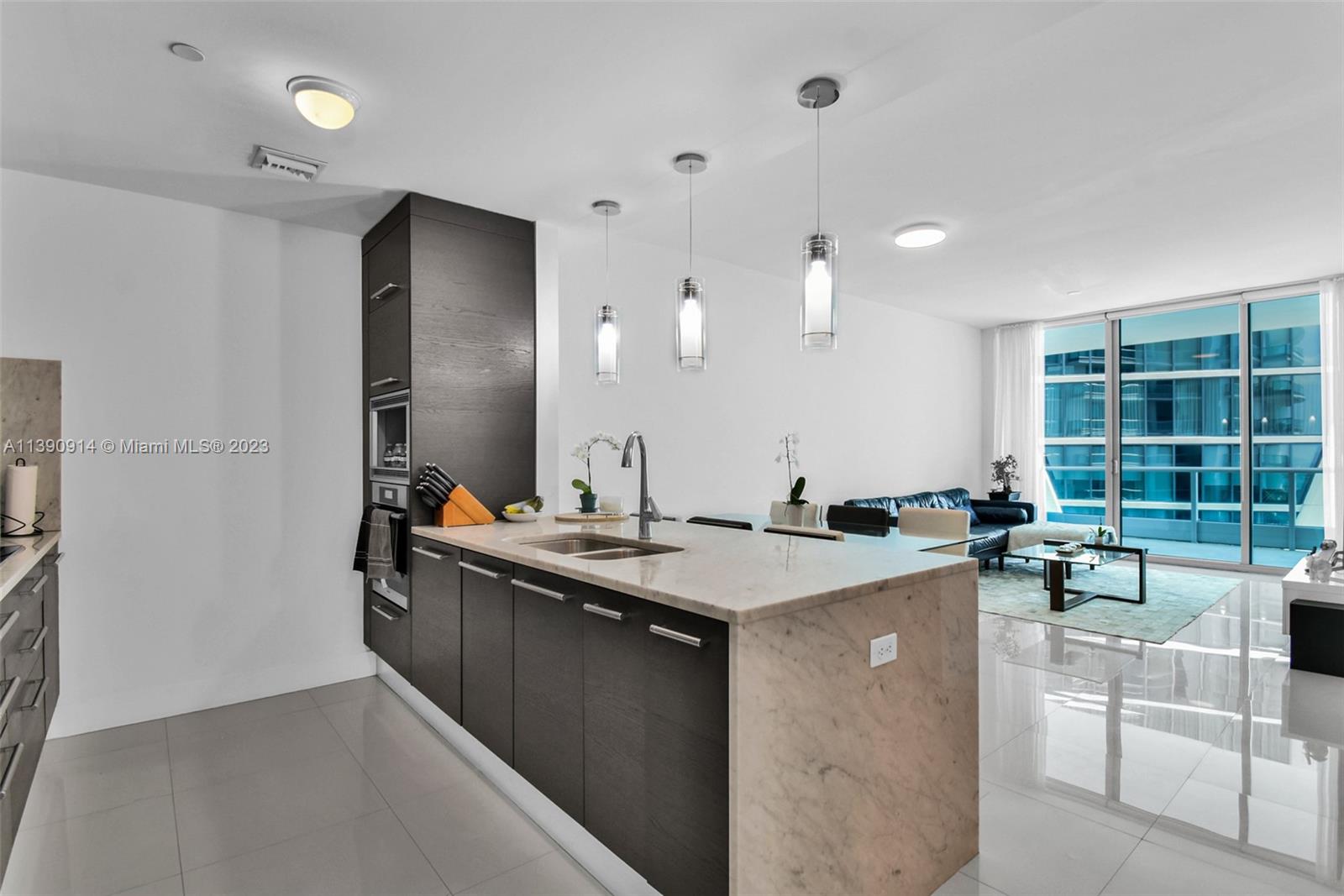 900 Biscayne Boulevard, Unit 4510 Miami, FL 33132 - Photo 10 of 48 a kitchen with a sink a counter top space and living room area