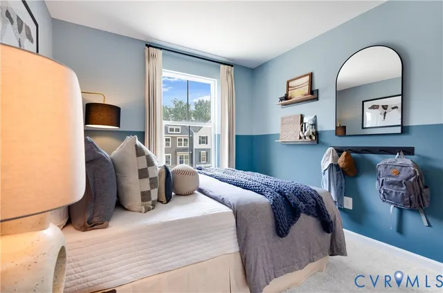 a bedroom with bed and a large window