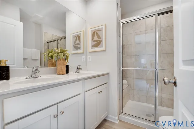 a bathroom with a shower sink and mirror