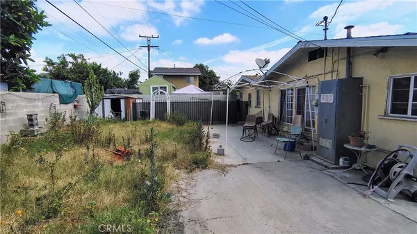 a view of a house with a wooden fence