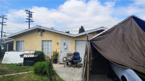 a backyard of a house with yard barbeque oven and outdoor seating