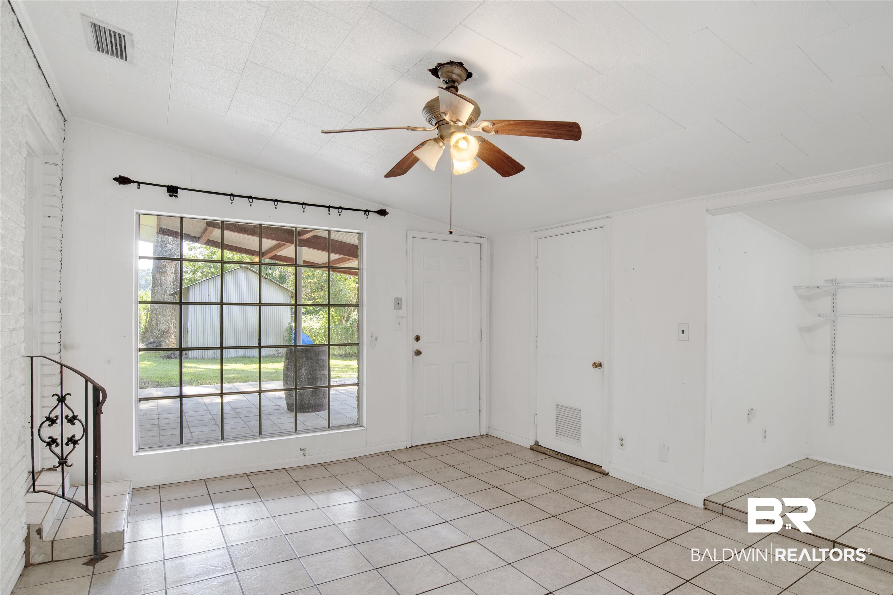 2 Lee Circle Daphne, AL 36527 - Photo 4 of 21 Tiled spare room featuring ceiling fan and lofted ceiling