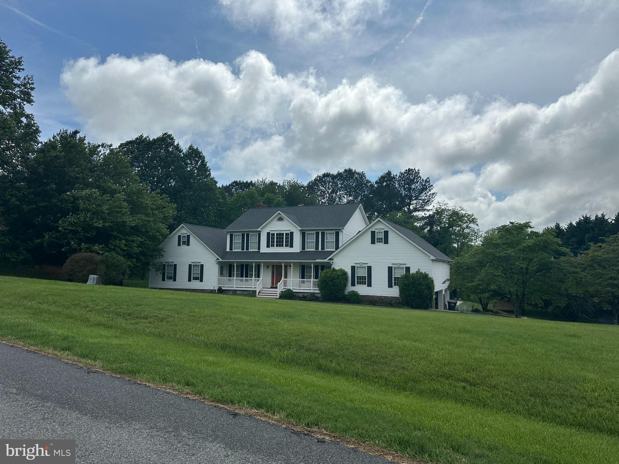 a view of house with yard and green space