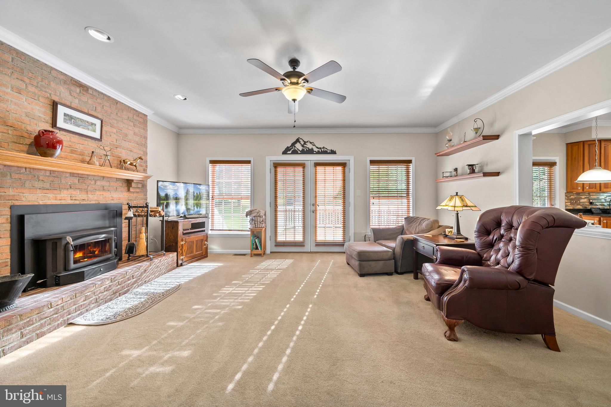 7950 Hampton Way Owings, MD 20736 - Photo 22 of 48 a large bedroom with furniture fireplace and a large window