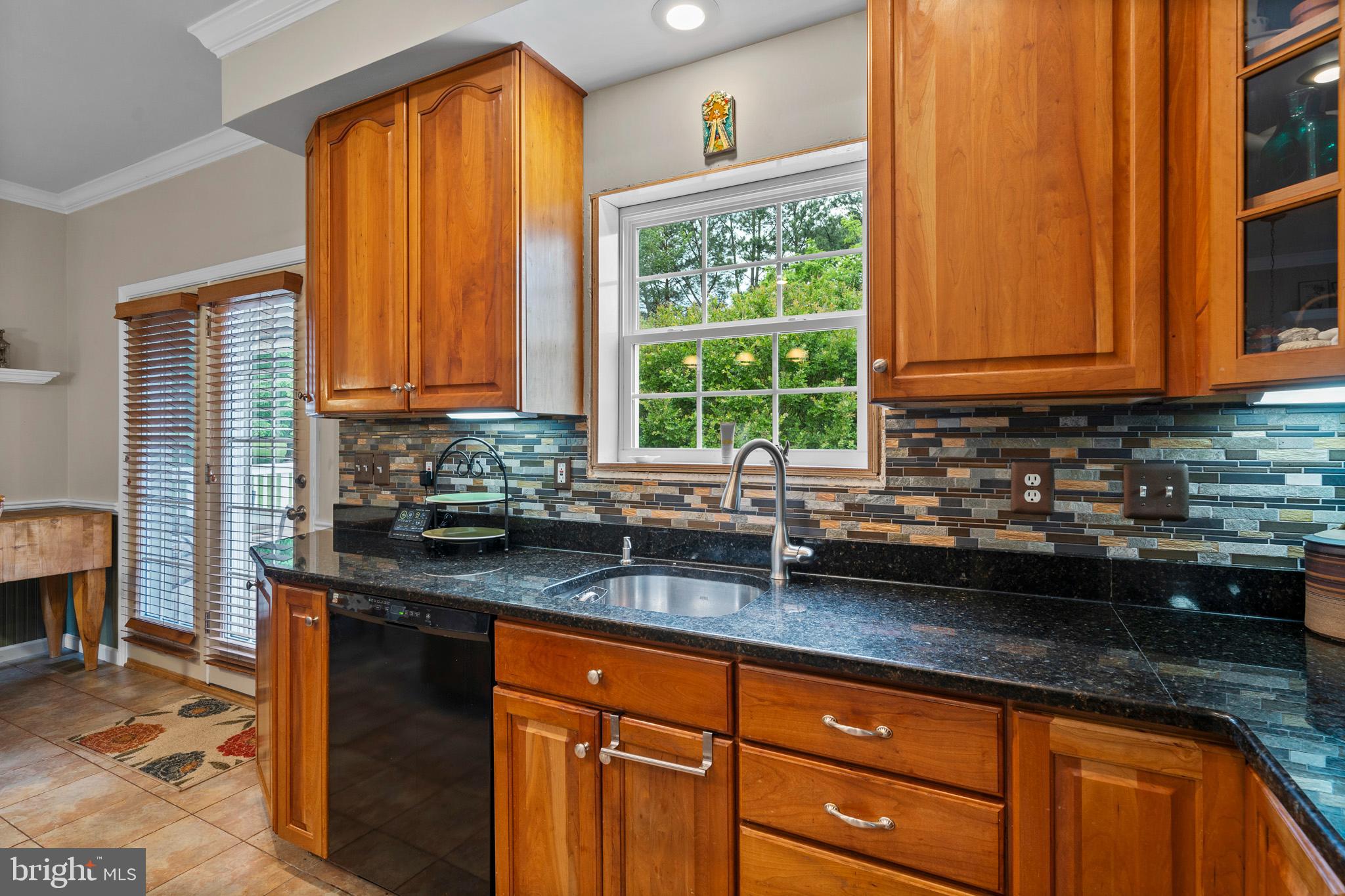 7950 Hampton Way Owings, MD 20736 - Photo 24 of 48 a kitchen with granite countertop a sink window and cabinets