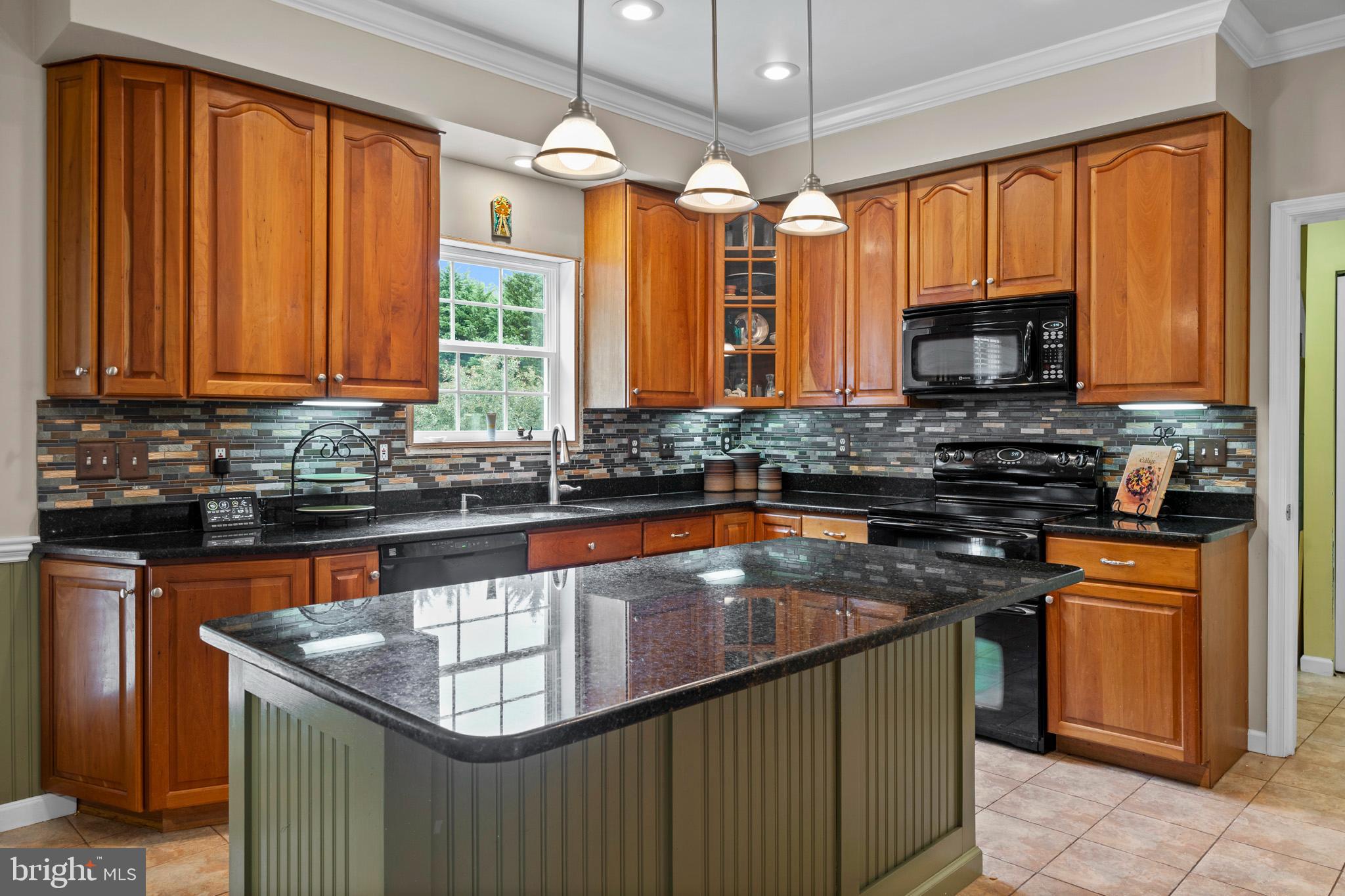 7950 Hampton Way Owings, MD 20736 - Photo 26 of 48 a kitchen with stainless steel appliances granite countertop a stove sink and cabinets