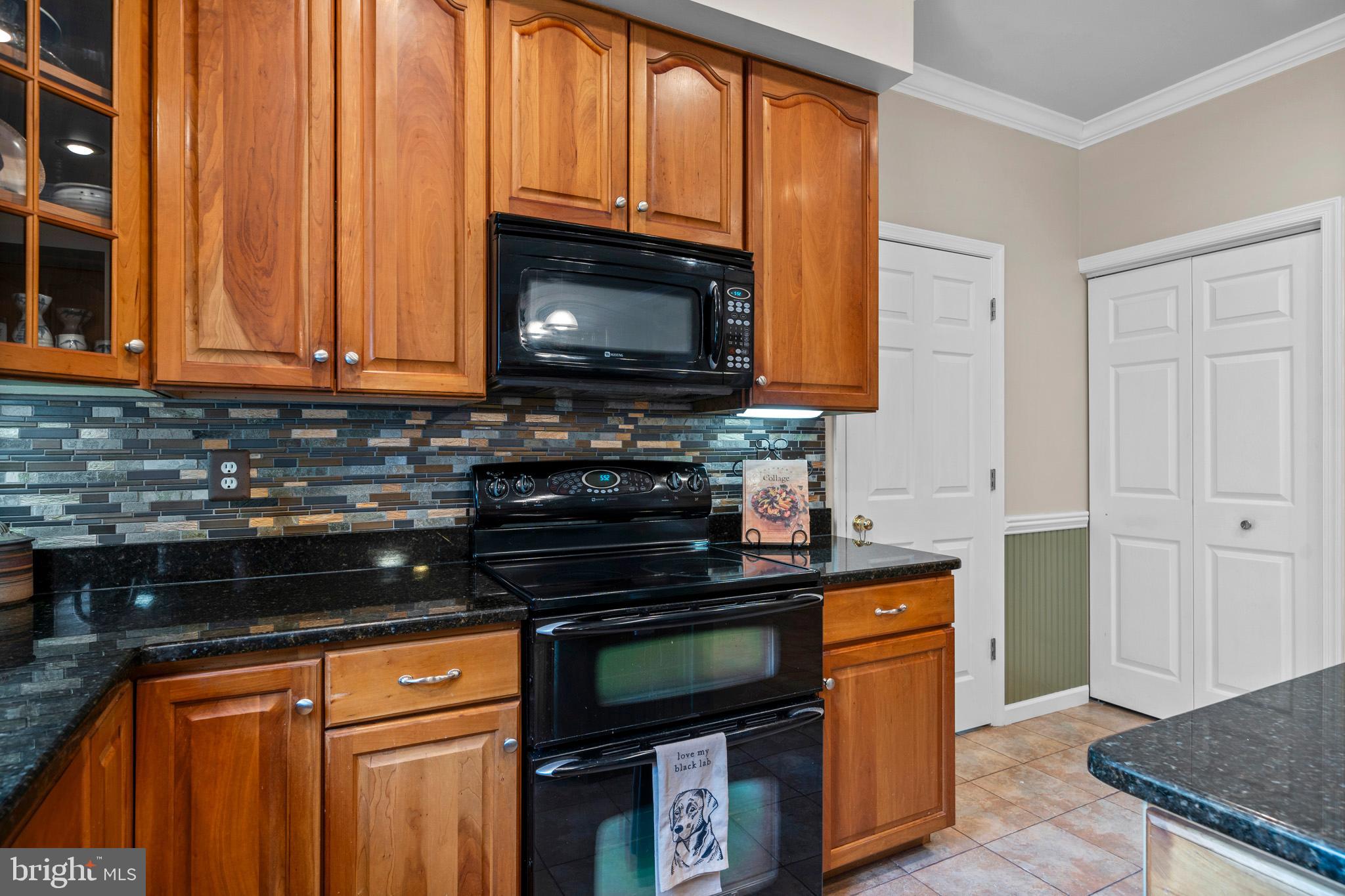 7950 Hampton Way Owings, MD 20736 - Photo 27 of 48 a kitchen with stainless steel appliances granite countertop a stove a sink and a microwave