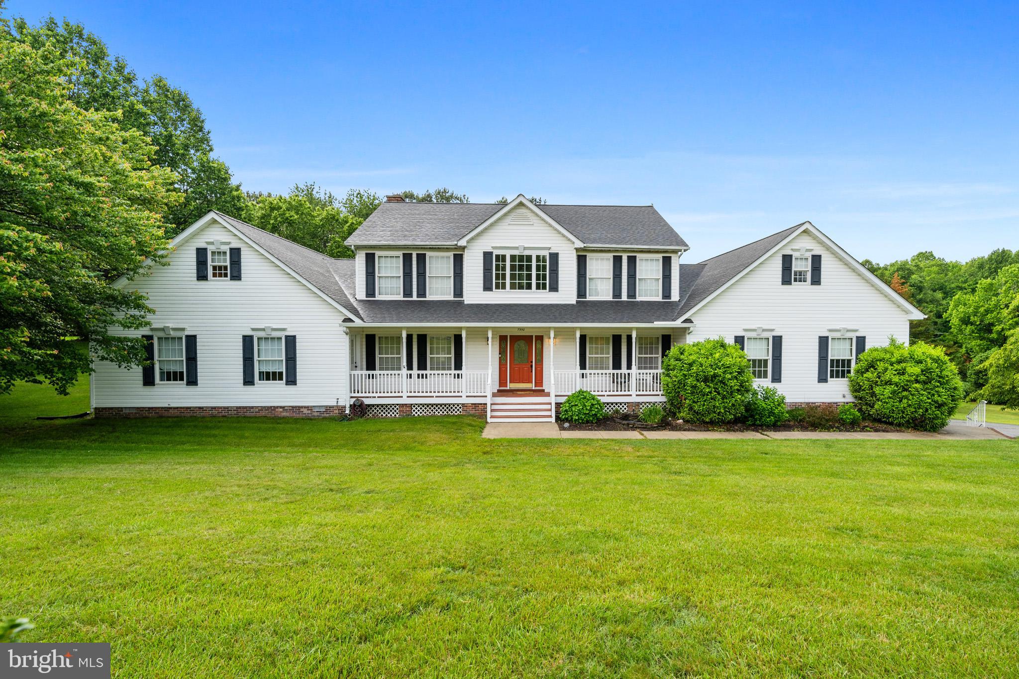 7950 Hampton Way Owings, MD 20736 - Photo 5 of 48 a front view of a house with a garden