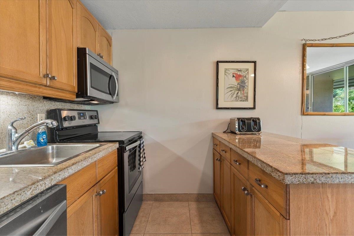 2495 South Kihei Road, Unit 254 Kihei, HI 96753 - Photo 11 of 30 a kitchen with stainless steel appliances granite countertop a sink stove and microwave