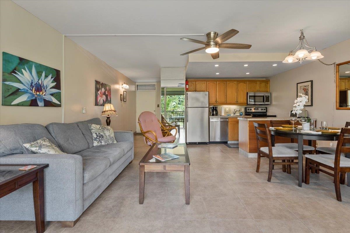 2495 South Kihei Road, Unit 254 Kihei, HI 96753 - Photo 20 of 30 a living room with furniture a chandelier and a dining table