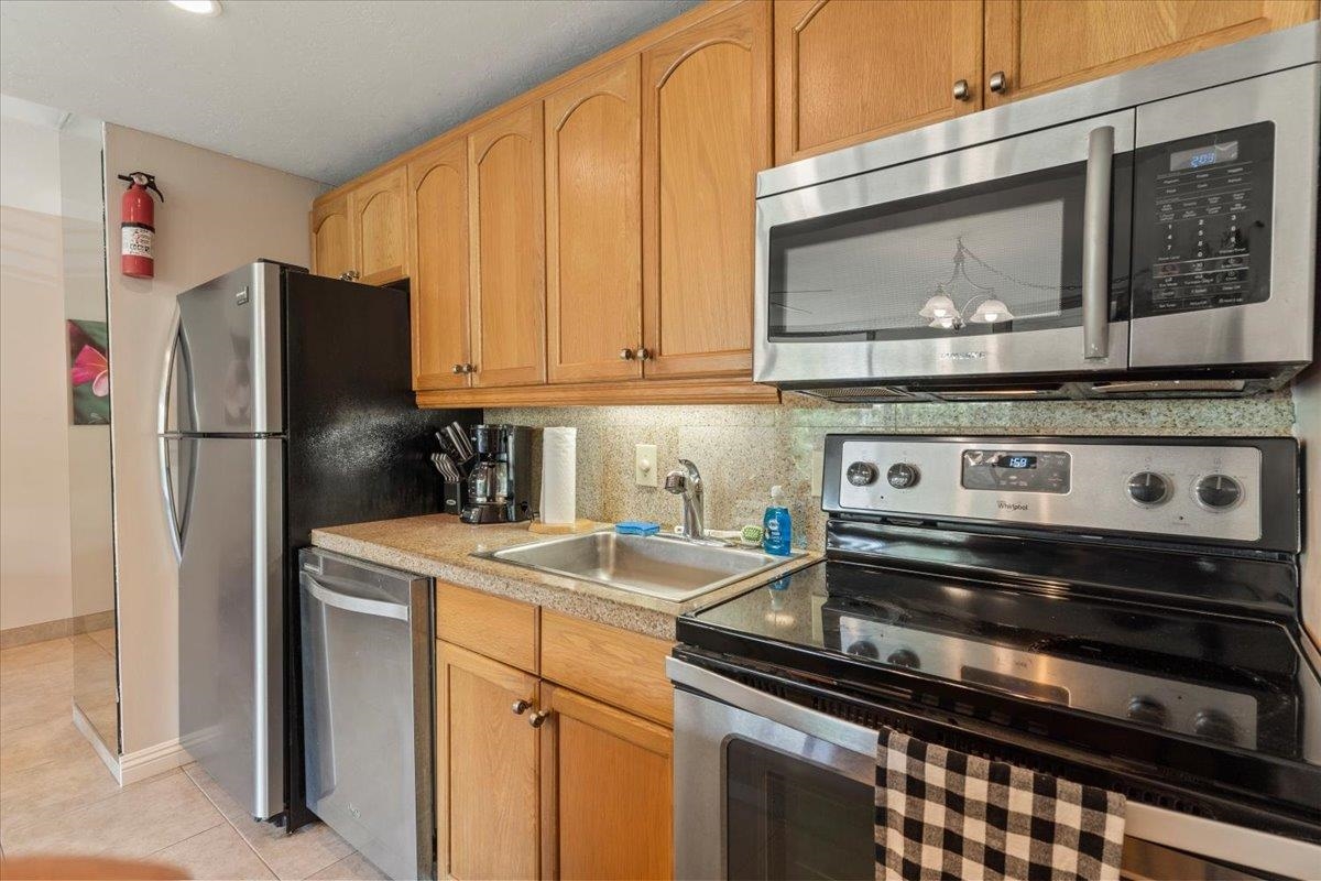 2495 South Kihei Road, Unit 254 Kihei, HI 96753 - Photo 21 of 30 a kitchen with a stove microwave and refrigerator
