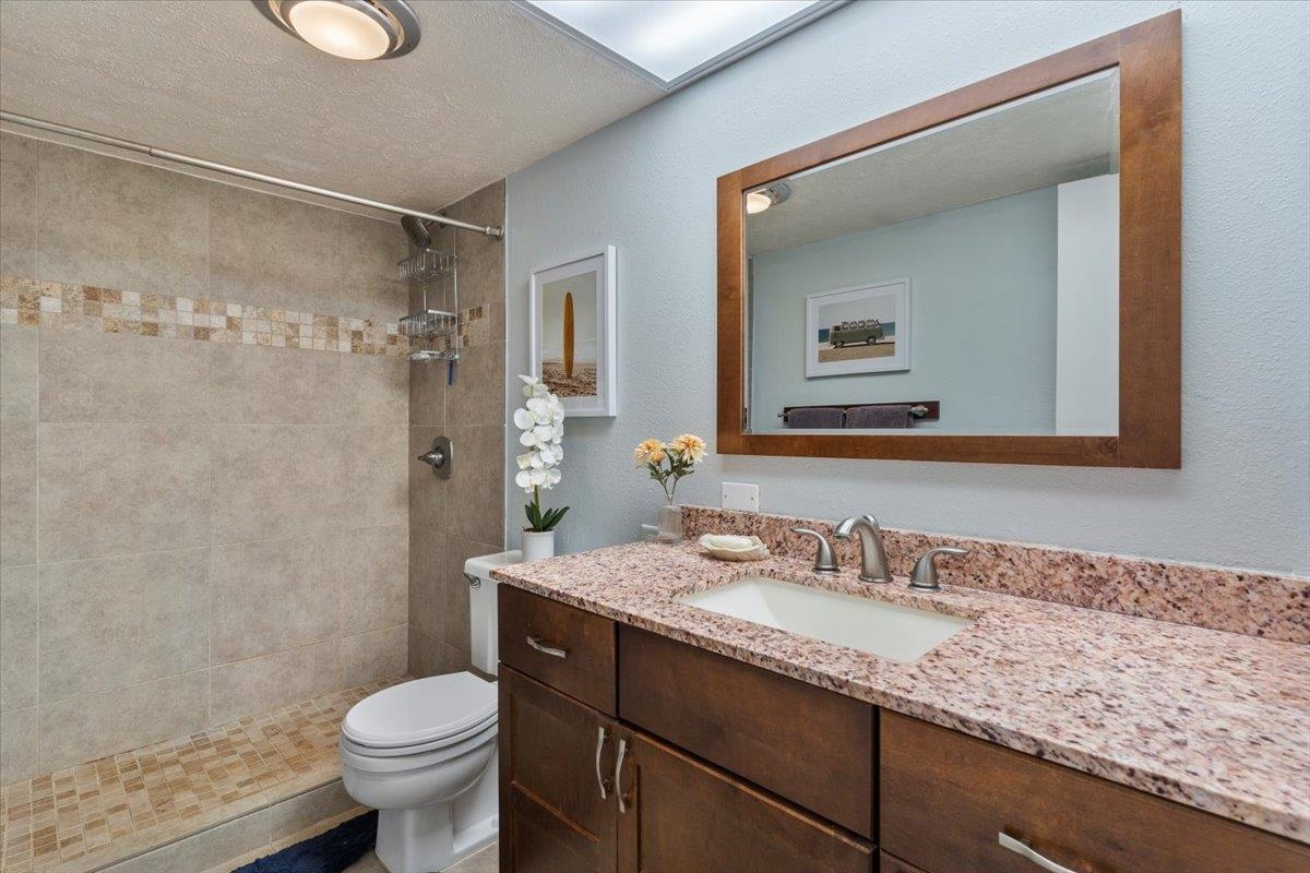 2495 South Kihei Road, Unit 254 Kihei, HI 96753 - Photo 25 of 30 a bathroom with a granite countertop sink toilet and shower