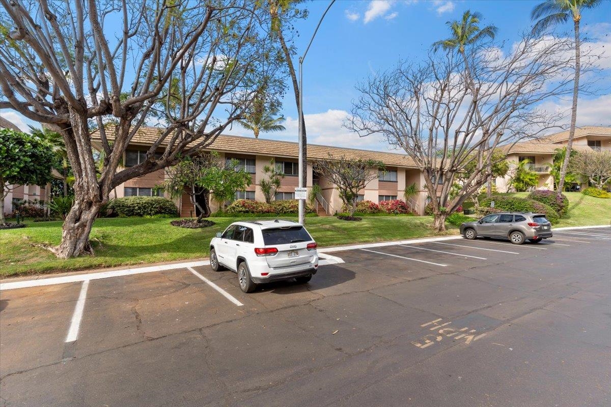 2495 South Kihei Road, Unit 254 Kihei, HI 96753 - Photo 30 of 30 a car parked in front of a brick house next to a yard