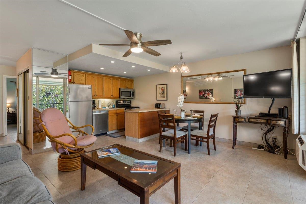 2495 South Kihei Road, Unit 254 Kihei, HI 96753 - Photo 6 of 30 a living room with furniture a flat screen tv and a kitchen