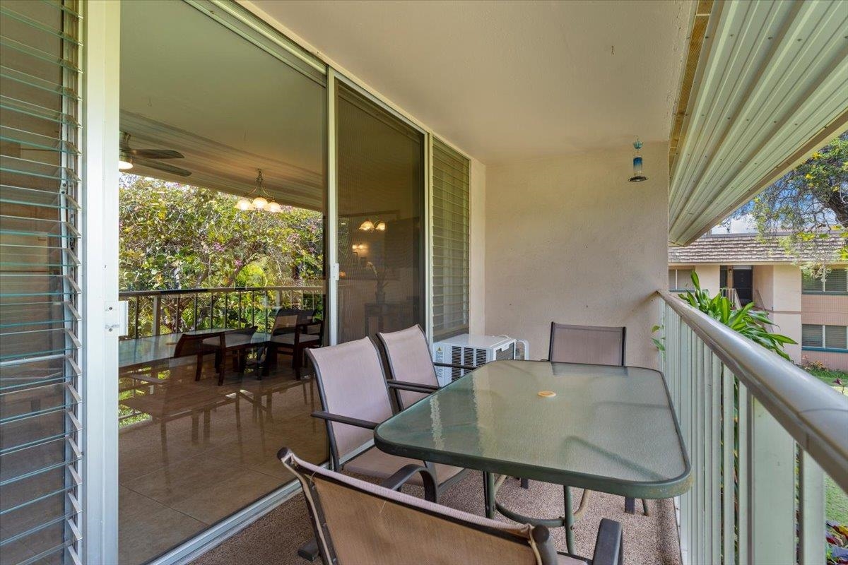 2495 South Kihei Road, Unit 254 Kihei, HI 96753 - Photo 9 of 30 a balcony view with a dining table and chairs with floor to ceiling window stairs and wooden floor