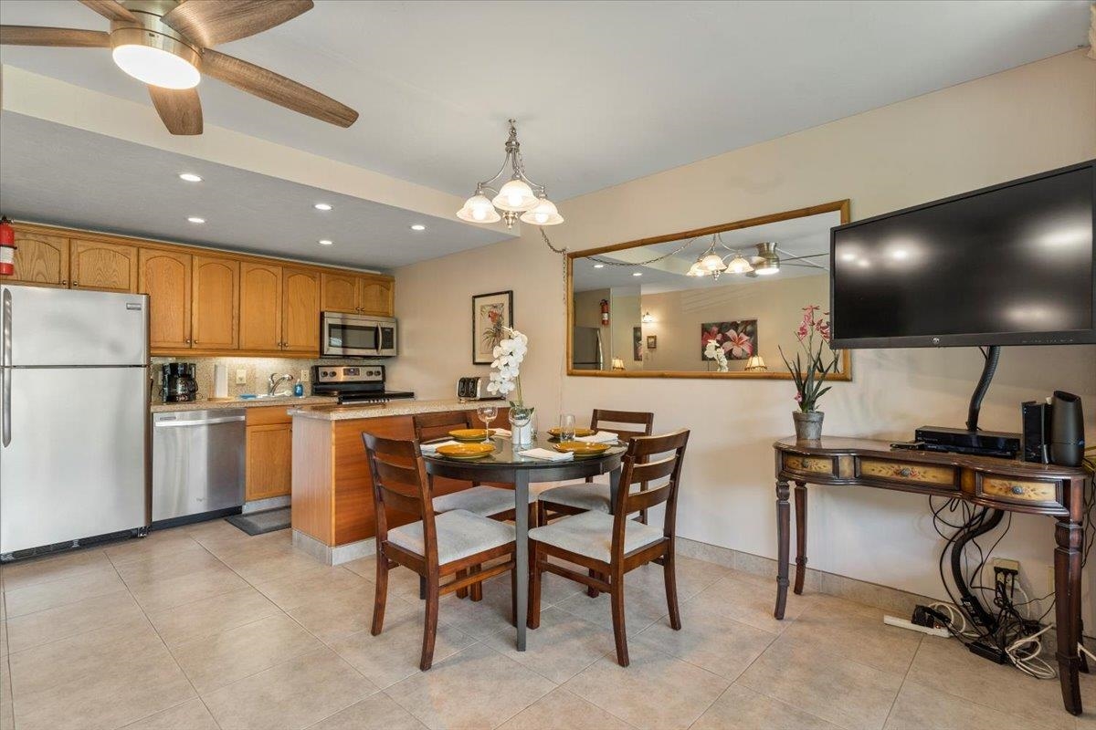 2495 South Kihei Road, Unit 254 Kihei, HI 96753 - Photo 10 of 30 a kitchen with cabinets and chairs