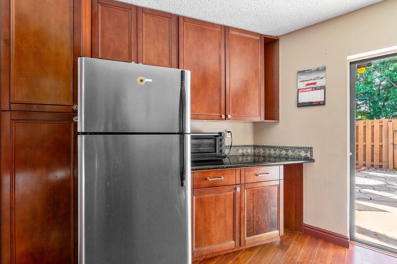 8140 Thames Boulevard, Unit C Boca Raton, FL 33433 - Photo 12 of 21 Refrigerator and view of courtyard
