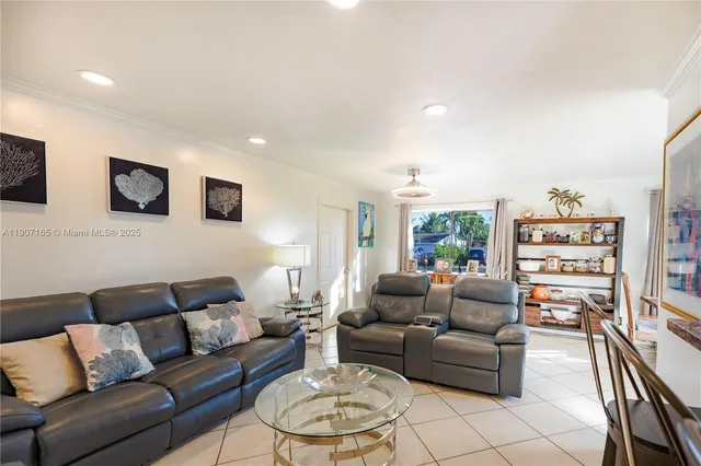 a living room with furniture a rug and a flat screen tv