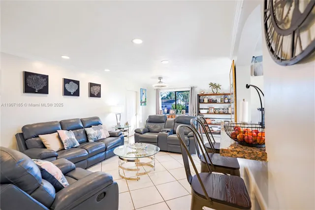 a living room with furniture a rug and a flat screen tv