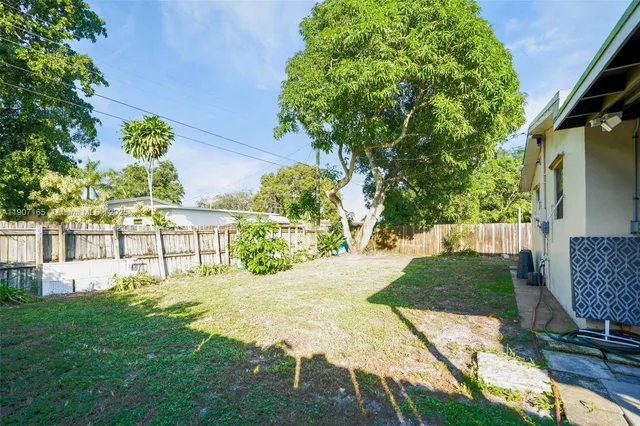 a garden with trees in front of it