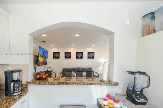 a view of living room with furniture and flat screen tv