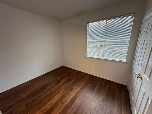 a view of an empty room and wooden floor