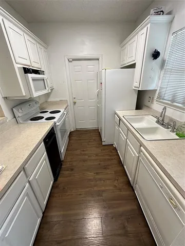 a kitchen with a sink stove and refrigerator
