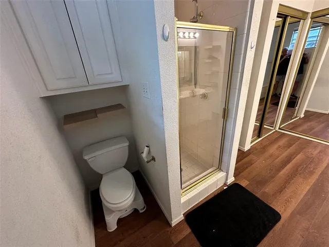 a white toilet sitting next to a bathroom