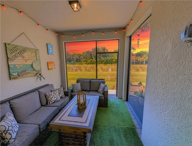 a living room with furniture and a floor to ceiling window